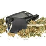 Driving high marijuana and car key isolated on white