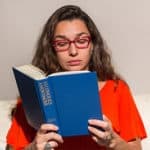 Woman reading Alcoholics Anonymous book